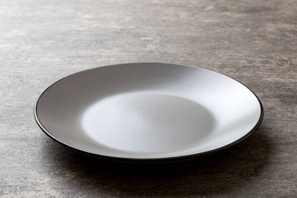 istock Perspective view of empty grey plate on cement background. Empty space for your design 1779771172