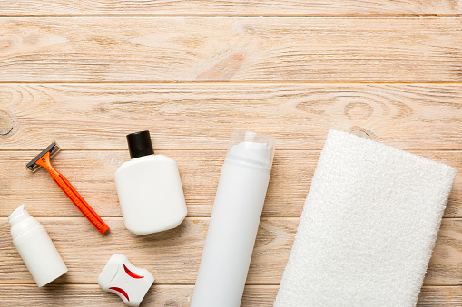 Composition with bath cosmetics on table. razor, toothpaste, soap, gel, toothbrush, mouthwash and other various accessories. Cosmetics for skin health. Bath Mockup for your logo.