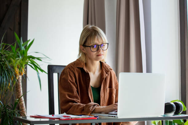 istock Middle age woman woking with laptop computer at home 1779777075
