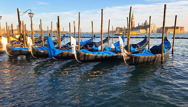 Beautiful seascape with gondolas on the blue sea water in Venice Beautiful seascape with gondolas on the blue sea water in Venice . couple punting stock pictures, royalty-free photos & images