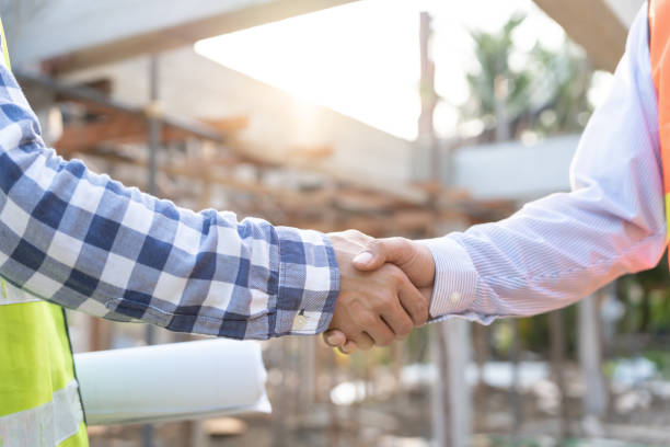 istock Construction team hands shaking greeting start up plan new project contract in office center at construction site, industry ,architecture, partner, teamwork, agreement, property, contacts. 1779794393