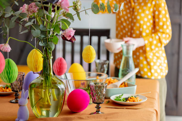 woman sets the Easter table. for dinner. True lifestyle stock photo