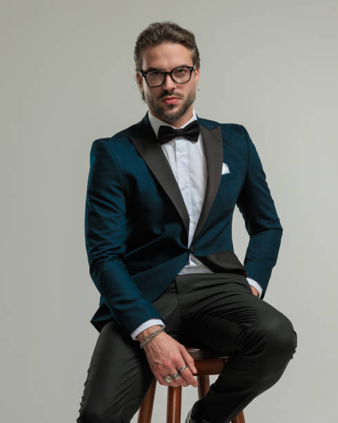 istock confident high class man in tuxedo with glasses sitting and posing 1779811482