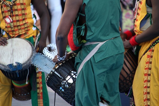 A lively folk exhibition showcasing traditional Kenyan culture outside in a festive atmosphere.