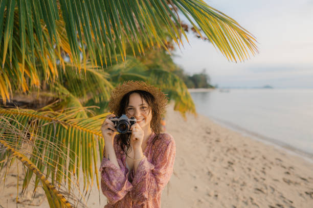 istock Woman making memories with vintage camera during beach vacation 1779819648