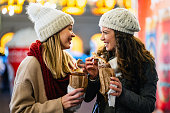 Happy people having fun together at a festive christmas fair. Christmas holiday people concept