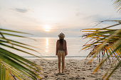 Woman in swimsuit walking  on the idyllic tropical beach