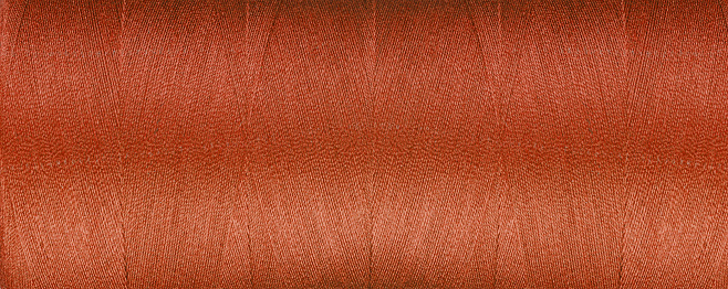 texture of threads for a brown sewing machine on a white background close-up