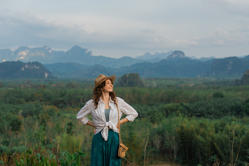 Young Caucasian woman looking at Khao Sok National park mountains