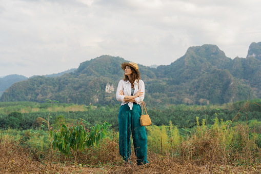 Young Caucasian woman looking at Khao Sok National park mountains