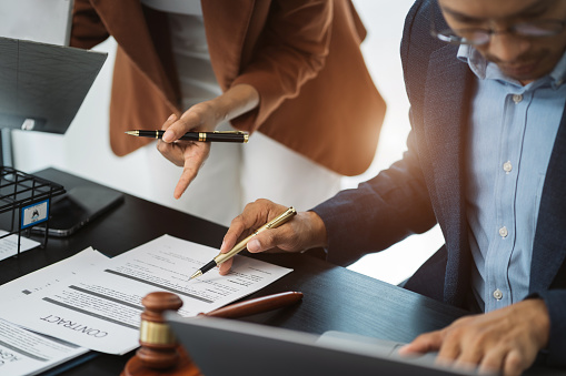 Business lawyer meeting working with paperwork on desk in office workplace for consultant lawyer in office.