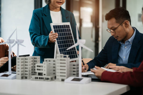 istock Business team brainstorming using tablet, laptop computer for working technology and business,  Renewable energy-based green businesses and global warming. 1779863143