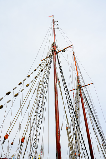 Collection of ropes around the mast of a sailboat.