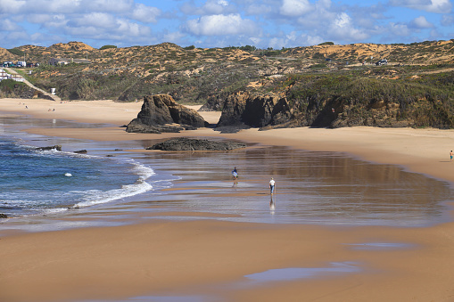 The Almograve beach with black basalt rocks in Alentejo coast, Portugal