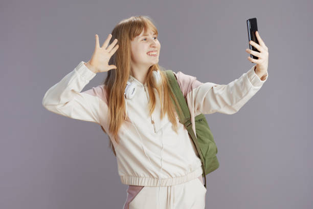 happy woman taking selfie and using smartphone app handwaving - number 12 audio imagens e fotografias de stock