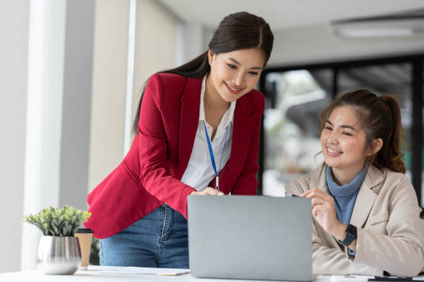 istock Two Asian businesswomen discuss working on a new project idea presentation. Calculate marketing plans and investments real estate tax office 1779882548
