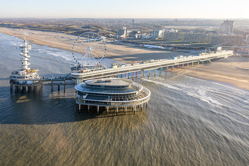 Aerial view Dutch Scheveningen Pier with Ferris wheel at Dutch coast