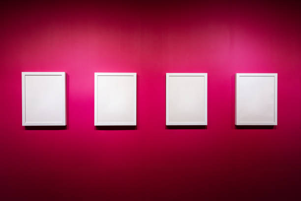 Collection of Blank white color picture frame templates for place image or text inside on the pink wall. Exhibition gallery.