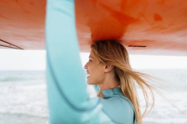 istock Surfer girl and her surfboard 1779901393