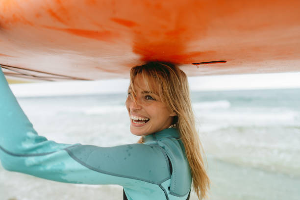 istock Surfer girl and her surfboard 1779901922
