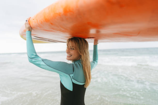 istock Surfer girl and her surfboard 1779901981