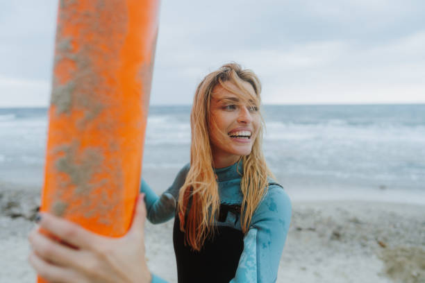 istock Surfer girl and her surfboard 1779902515