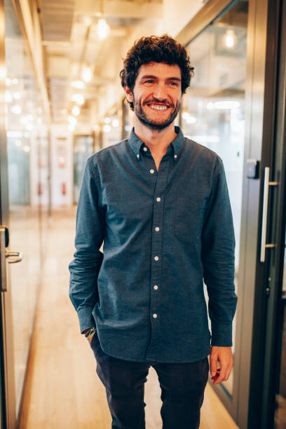istock Cheerful male entrepreneur standing in office corridor 1779909888