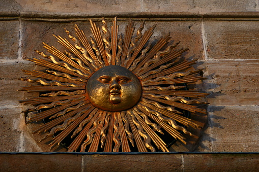 The sun above an entrance gate in the historic center of Solsona, Catalonia