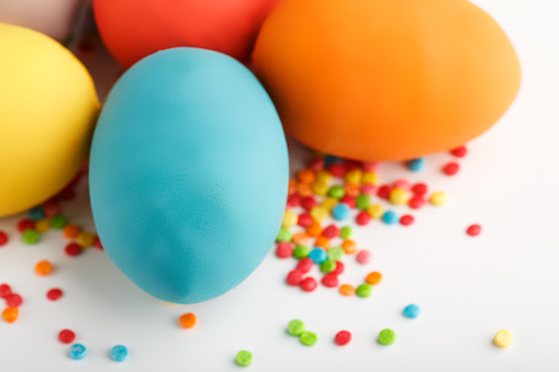 Bright color painted boiled eggs in egg carton. Easter decoration close up shallow depth of field