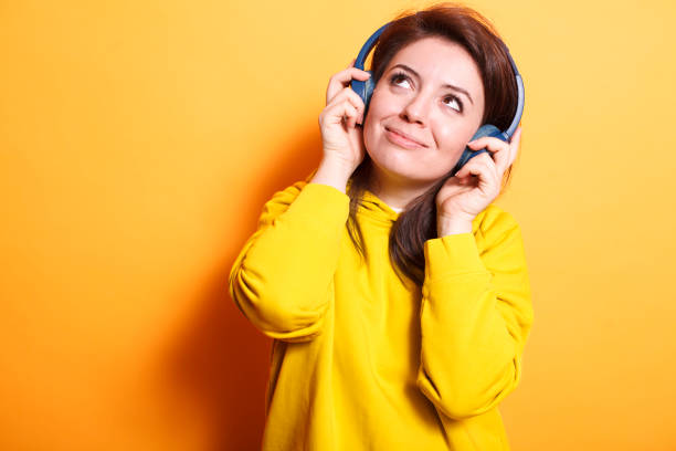 istock Smiling woman enjoying relaxing songs 1779941091