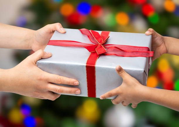 istock mother giving christmas present to her child 1779948361