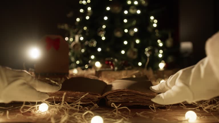 Santa Claus open a old book under tree