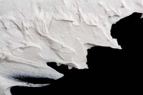 istock Structural plaster white on a black background. White Cream. paint smear. Plasticine 1779950618