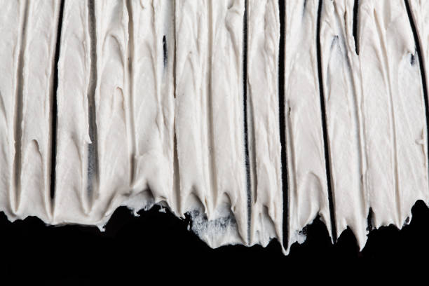 istock Structural plaster white on a black background. White Cream. paint smear. Plasticine 1779950647