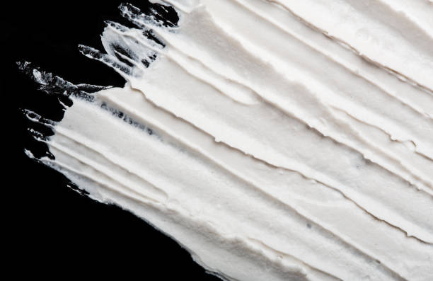istock Structural plaster white on a black background. White Cream. paint smear. Plasticine 1779951654