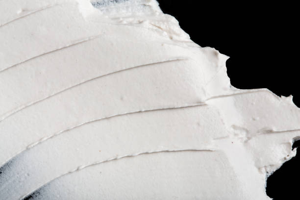 istock Structural plaster white on a black background. White Cream. paint smear. Plasticine 1779952339