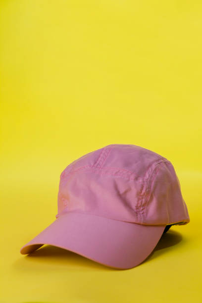 istock A pink cap on a yellow background 1779961781