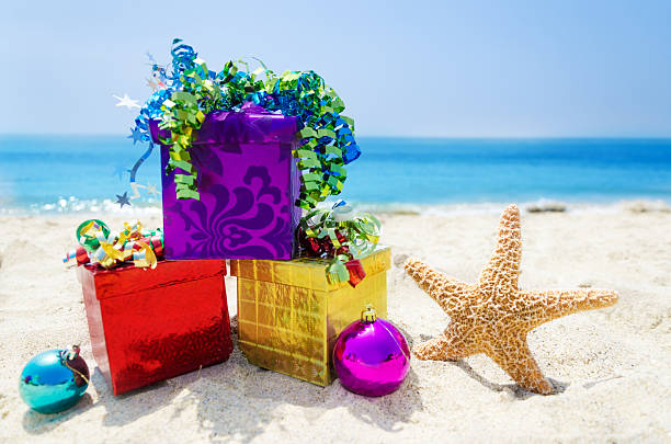 istock Starfish with Christmas balls and gift on the beach 177997096