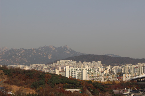 Apartment buildings nestled between mountains and trees in Seoul