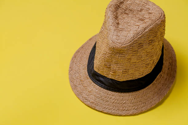 istock Straw hat on yellow background with summer theme 1779998990