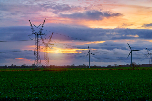 Windmill in agricultural field in twilight