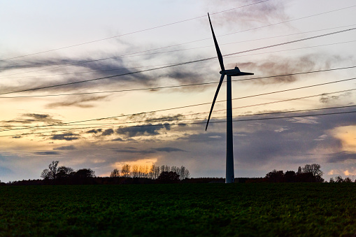Windmill in agricultural field in twilight