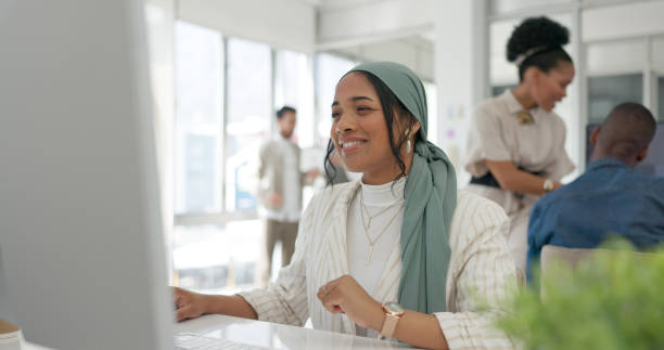 istock Woman in office, smile and reading on computer for email feedback, review or article summary. Website, market research report and happy media employee with online survey or analysis for web business. 1780010405