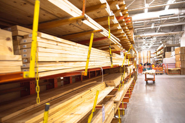 istock Selective focus timber shelves aisle with lumber cart, home improvement hardware store, chain link preventing warehouse rack collapse, building material framing, house, sheds construction 1780018492