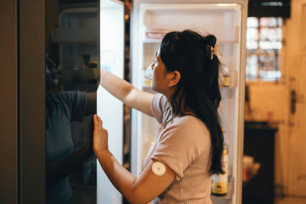 One woman, beautiful female using taking soda from refrigerator in kitchen. at home