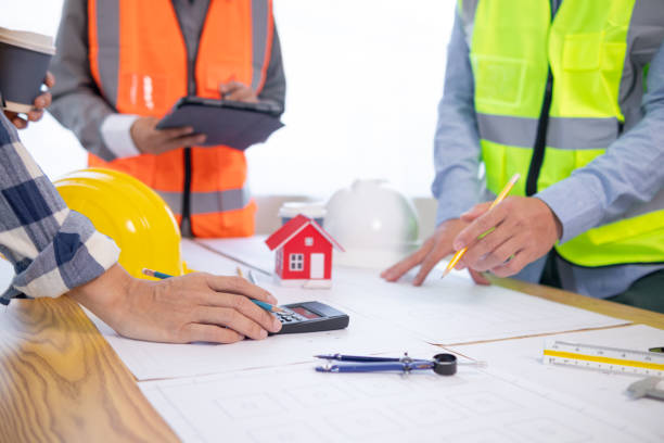 istock Architects and construction engineers meet to discuss blueprints of building structures in order to calculate the completion of the construction project. Real estate construction business concept. 1780032035