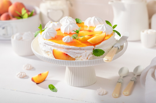 Tasty peach meringue made of whipped cream and fruit. Peach meringue made of fruits and cream.