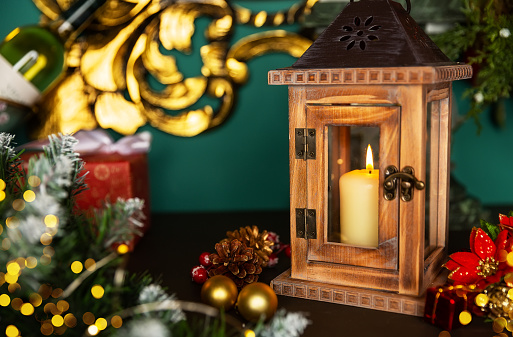 Holiday greeting card design with Christmas scene. Lantern with candle and Christmas decorations on a old wooden table