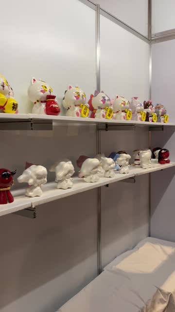 Maneki-neko cats Lucky Cats or Fortune Cats at the store exhibition. Vertical