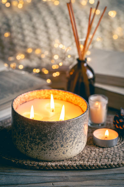 istock Cozy winter composition with candles on a blurred background with books. 1780062444